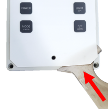 Overlay lifted with scraper at corner of label