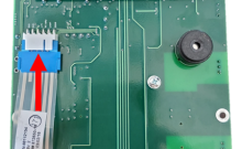 Push ribbon cable onto overlay button connection contacts