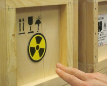 Radiation marker on wooden box with hand pointing to the left