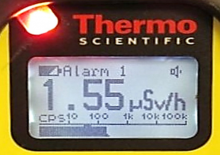 Alarm of gamma radiation with red LED in upper left