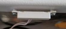 Remove two screws of tamper switch using a medium Phillips screwdriver